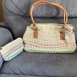 No brand name, leather straps.  Looks like crochet/knitted with ribbons woven.